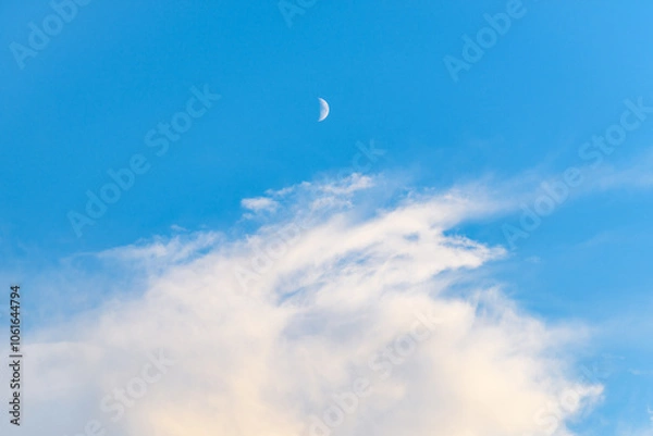 Fototapeta White Cloud and Crescent Moon Fading into Early Morning Blue Sky — Minimal Nature Composition