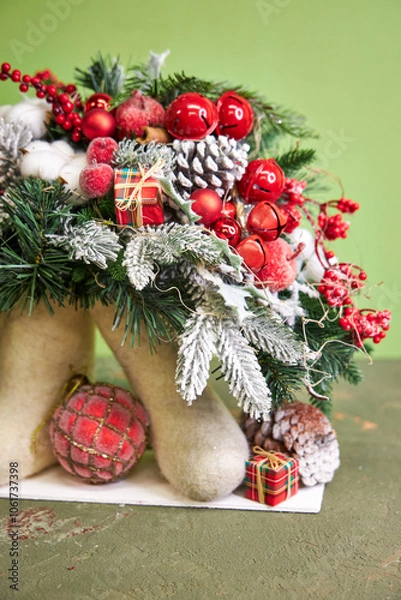 Obraz Christmas composition with pine needles and red decorations in felt boots