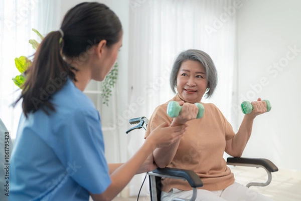 Obraz Friendly caregiver helping senior woman with dumbbell exercise at home, supporting health, wellness, and active aging. Elderly care assistance for physical therapy and trust.