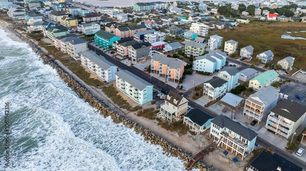 Obraz Aerial view of coastal residential properties vulnerable to climate change effects, facing rising insurance costs and increased risk from hurricanes and natural disasters.