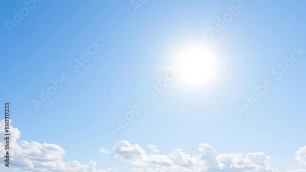 Fototapeta Fluffy white clouds covering a clear blue sky on a sunny day, serene, atmosphere