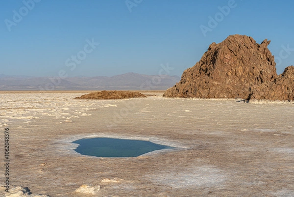 Fototapeta Plain of salt with salty pond and salt rocks in the Danakil Depression in Ethiopia