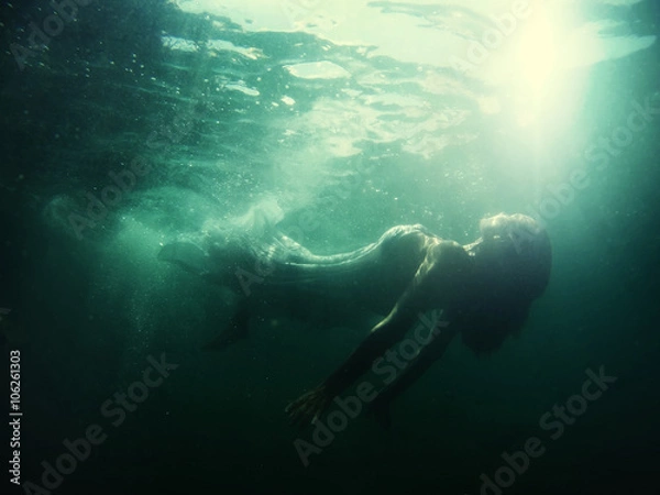 Obraz Woman floats underwater