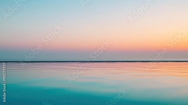 Fototapeta Serene ocean view during sunset with soft pastel sky colors and calm water.