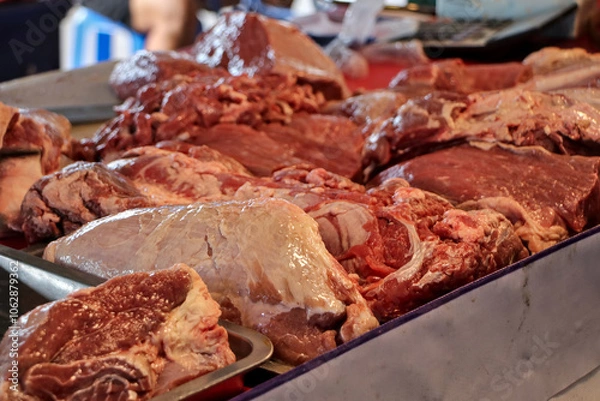 Fototapeta Close-up of cut pieces of meat on a table ready for sale.