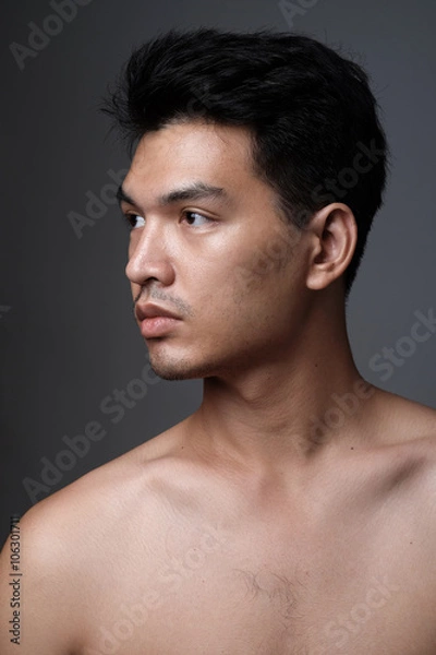 Fototapeta Asian man portrait with no makeup show his real skin in grey background - soft focus