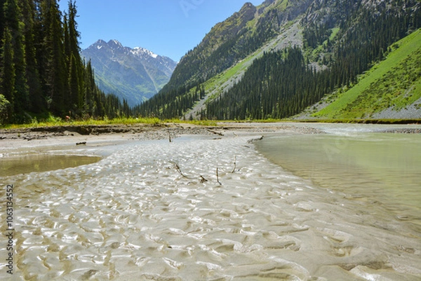 Fototapeta Idyllic summer landscape with hiking trail in the mountains with beautiful fresh green mountain pastures, river with reflection and forest.