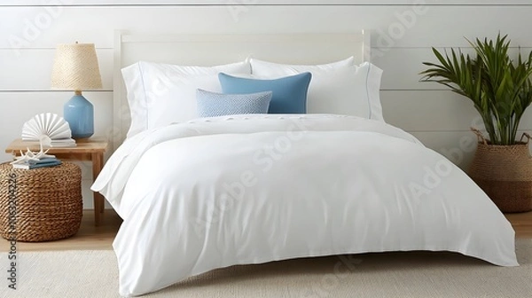 Fototapeta Serene and Relaxing Coastal Inspired Bedroom with Soft Blue Accents White Bedding and Elegant Beach Themed Decor Elements Creating a Calming and Inviting Atmosphere