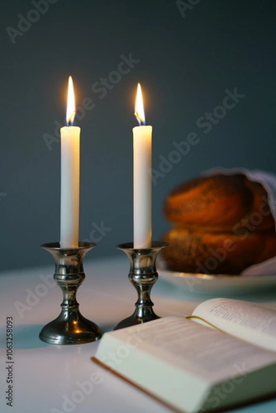 Obraz vertical photo Shabbat or Sabbath kiddush ceremony composition with a traditional sweet fresh loaf of challah bread, glass of red kosher wine and candles on a vintage wood table with copy space