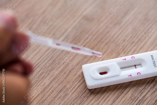Fototapeta Close up of HIV self-testing kit with Negative test on wooden table.