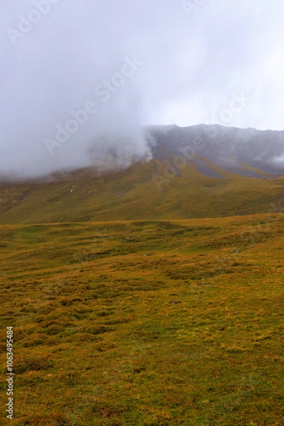 Fototapeta A mysterious atmosphere in the Swiss Alps! An extremely beautiful landscape in the autumn season.