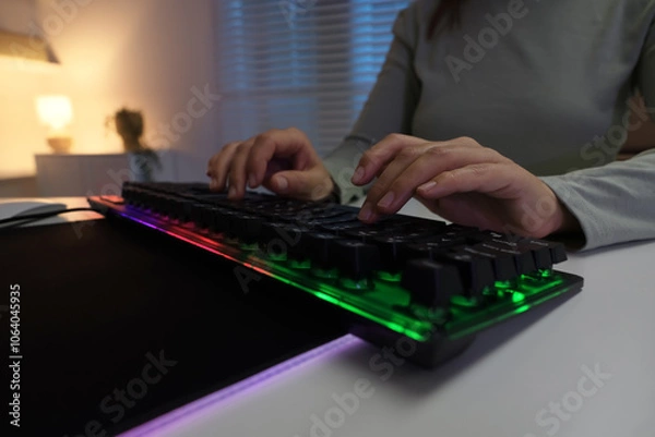 Fototapeta Woman using computer keyboard at white table indoors, closeup