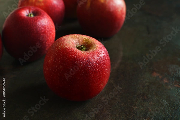 Fototapeta Fresh wet red apples on dark background