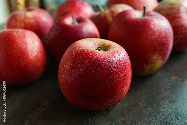 Fototapeta Fresh wet red apples on dark background