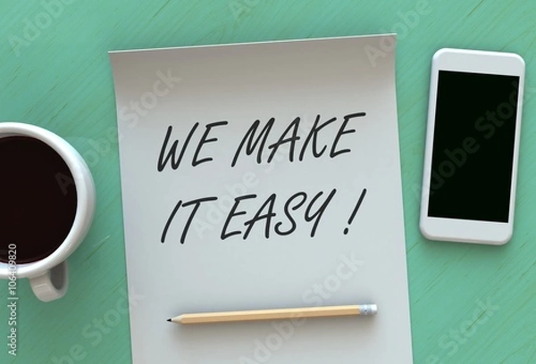 Fototapeta WE MAKE IT EASY, message on paper, smart phone and coffee on table