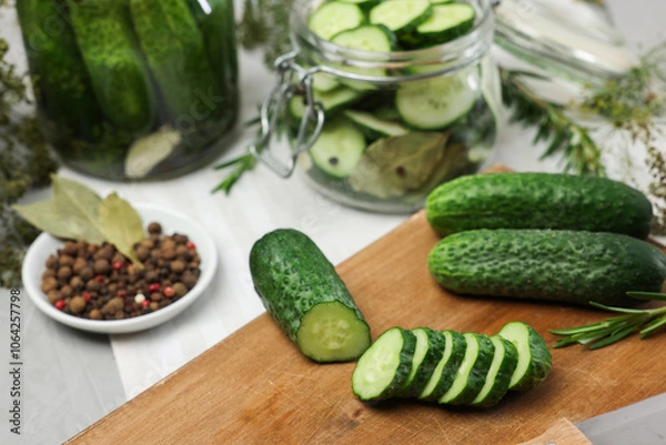 Obraz Fresh cucumbers and spices on light table, closeup. Preparation for pickling