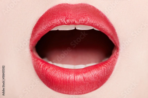Fototapeta Closeup view of female wearing red lipstick with mouth open