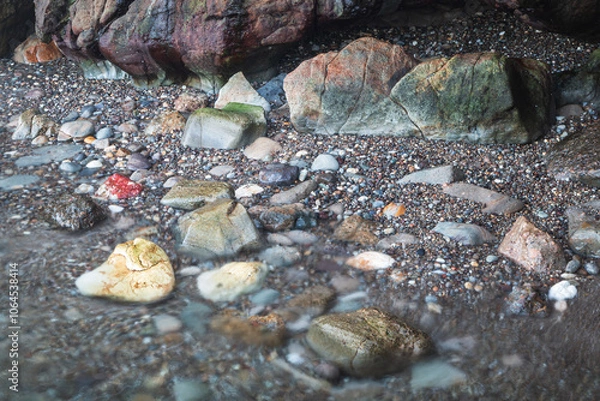 Fototapeta rocks and pebbles at beach on broughton island hawks nest nsw australia