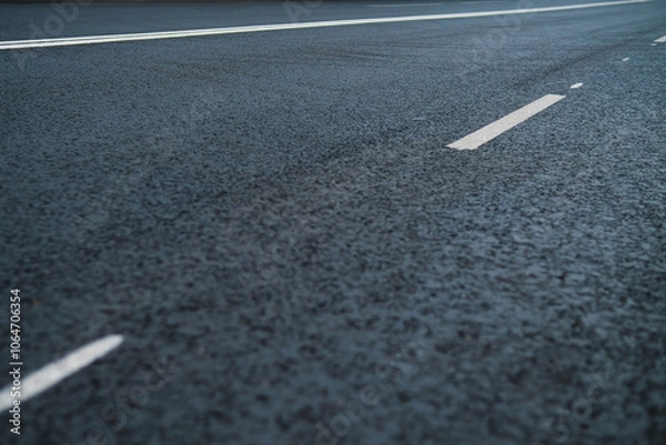 Fototapeta Asphalt highway with road markings lines