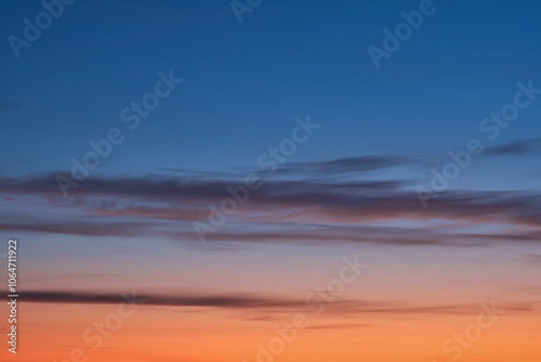 Obraz Beautiful sunset and sunrise. Dark moody blue and orange sunset sky. Natural background. Simple background sky for poster or mock up. Soft focus.
