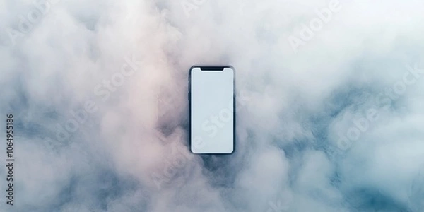 Fototapeta iPhone placed on a white backdrop surrounded by a gentle, soft fog, creating an appealing and serene atmosphere around the device.