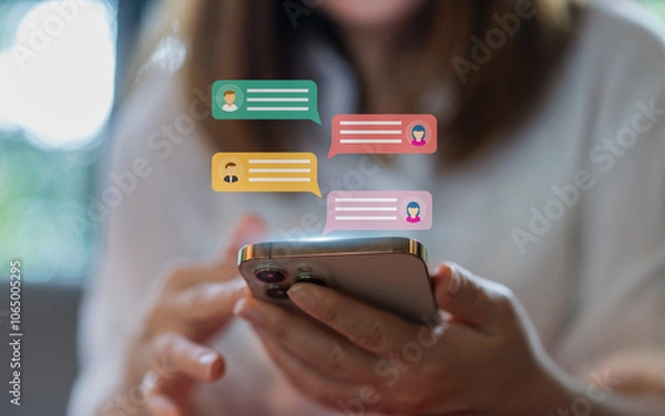 Fototapeta Human hand using smartphone typing Live chat chatting and social network concepts, chatting conversation working at home in chat box icons pop up. Social media marketing technology concept