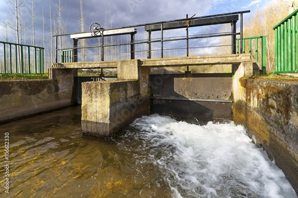 Obraz water canals to irrigate fields  in rural countryside