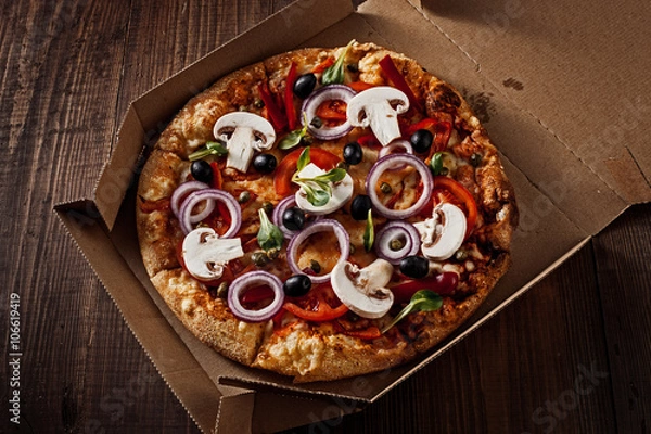 Obraz pizza in the in delivery box on the wood