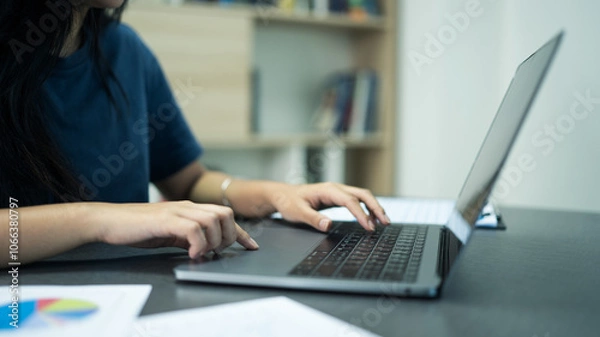Obraz busineswomen using computure to working on tax document and paying tax.