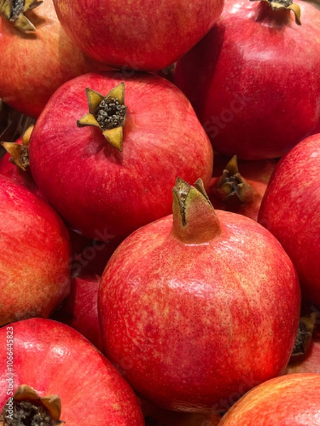 Fototapeta Close-up of fresh pomegranates. Background image of ripe pomegranates.
