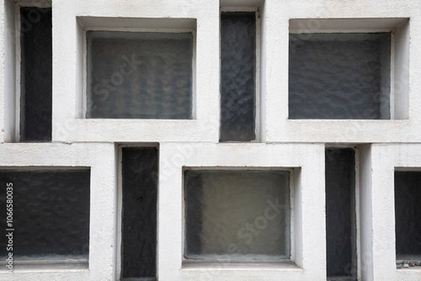 Fototapeta windows on a brick wall, abstract and geometric wall with white stone frames and windows