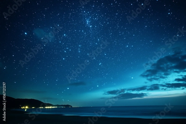 Fototapeta Starry night sky with clouds over a beach, night sky with stars and clouds