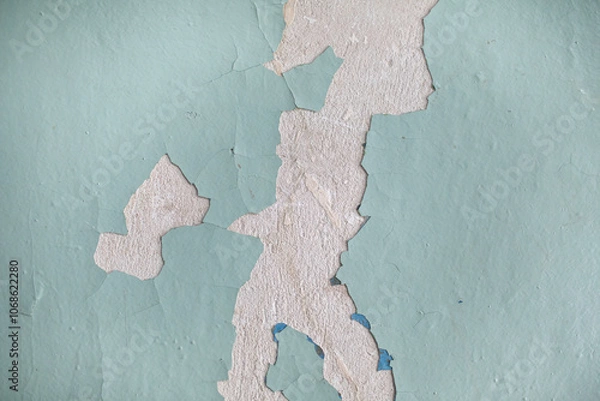 Obraz Cracked, peeling paint on the wall. A wall with old cracked blue paint. Patterns of cracks.