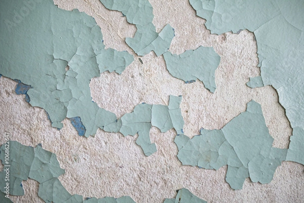 Obraz Cracked, peeling paint on the wall. A wall with old cracked blue paint. Patterns of cracks.