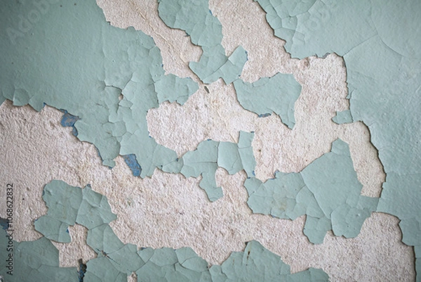 Obraz Cracked, peeling paint on the wall. A wall with old cracked blue paint. Patterns of cracks.