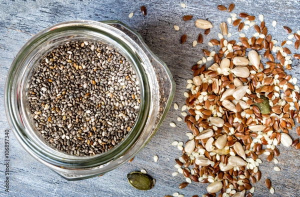 Fototapeta Mixed seeds and a jar of chia seeds