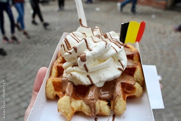 Fototapeta Delicious Belgian Waffle with Whipped Cream and Chocolate Sauce