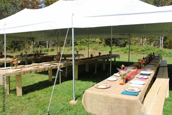 Fototapeta  Outdoor Tent Setup with Rustic Tables for Wedding