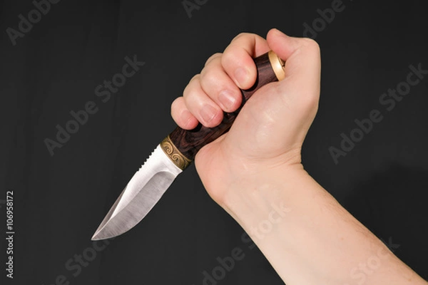 Fototapeta Man's hand holding knife