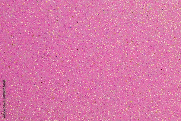 Fototapeta A pink background with glitter is displayed. The glitter is pink and gold, creating a shimmering effect