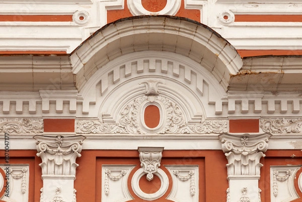 Fototapeta A fragment of the facade of an old mansion decorated with various stucco