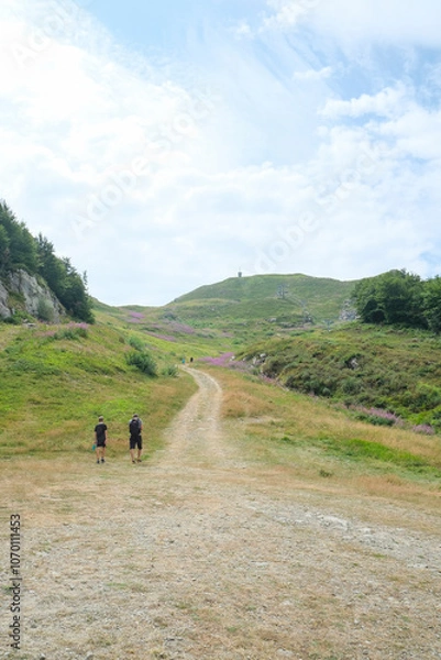 Fototapeta Two hikers in the mountains walking to the top. Mountain La Nuda, Appenino-Tosco emiliano, Emilia-Romagna, Italy