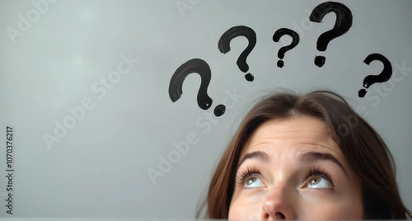 Fototapeta A woman's face is depicted in a light grey background, with curious expressions with hand drawn question marks upon her head.