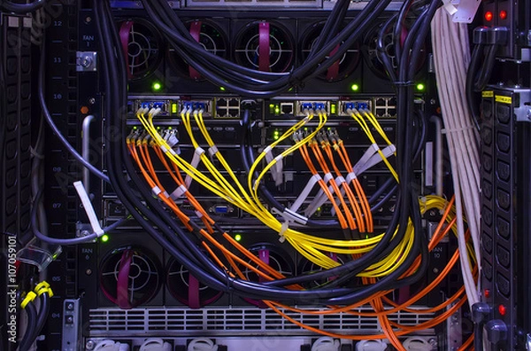 Obraz rear of the device with lots of computer cables and patch cords