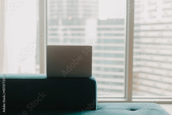 Obraz Laptop against the background of a skyscraper window.