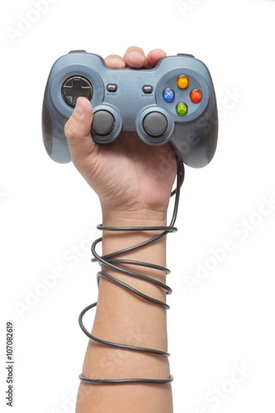 Obraz hand holding game controller and tied up with cables