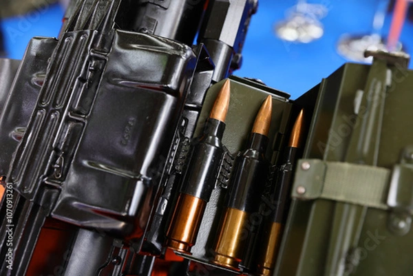 Fototapeta Ammunition presented by an arms manufacturer at an exhibition where the latest technologies in the field are presented to the public and those present. Arms industry