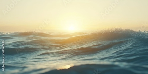 Fototapeta Tranquil ocean waves under setting suns golden light