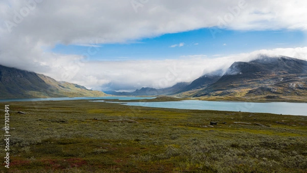Fototapeta Breathtaking scenic view to the wide mountain valley with lakes and mountains on horizon, splendid scandinavia landscape seen while hiking Kungsleden trail in nordic nature of swedish Lapland. Sweden