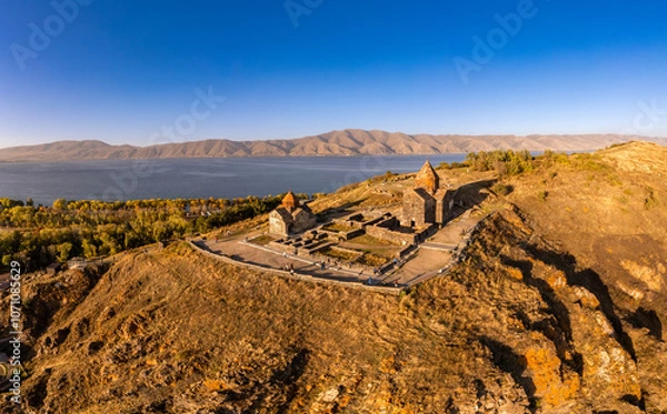 Fototapeta Aerial panoramic view of Surp Arakelots Holy Apostles church and chapel. Ancient Sevanavank Monastery complex and Sevan lake on sunny summer day. Travel and tourist destinations. Armenia, Europe.